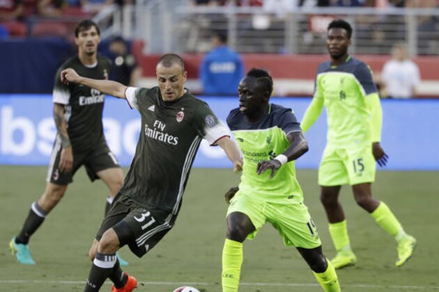 Liverpool's Sadio Mane, right, dribbles as AC Milan defender Luca Antonelli (31) closes in during the first half of an International Champions Cup soccer match Saturday, July 30, 2016, in Santa Clara, Calif. (AP Photo/Marcio Jose Sanchez)