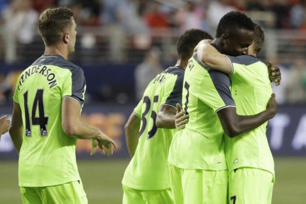 Liverpool's Divock Origi, center, is hugged by teammate James Milner, right, after Origi's goal against AC Milan during the second half of an International Champions Cup soccer match Saturday, July 30, 2016, in Santa Clara, Calif. Liverpool won 2-0. (AP Photo/Marcio Jose Sanchez)