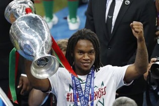 Portugal's Renato Sanches celebrates with the trophy after Portugal won the Euro 2016 final soccer match between Portugal and France at the Stade de France in Saint-Denis, north of Paris, Sunday, July 10, 2016. (AP Photo/Michael Sohn)