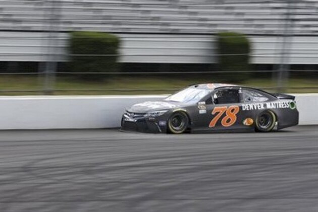 Martin Truex Jr. (78) drives at Pocono Raceway during qualifying for Sunday's NASCAR Sprint Cup Series Pennsylvania 400 auto race Friday, July 29, 2016, in Long Pond, Pa. Truex qualified on the pole. (AP Photo/Mel Evans)