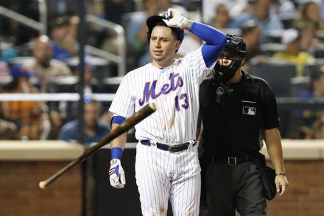 Home plate umpire Mark Wegner stands behind New York Mets Asdrubal Cabrera (13), who removes his helmet after tossing his bat after Wegner called him out on strikes looking with a runner on third for the third out in the fifth inning of a baseball game against the St. Louis Cardinals, Wednesday, July 27, 2016, in New York. (AP Photo/Kathy Willens)