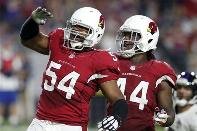 Arizona Cardinals linebacker Dwight Freeney (54) salutes the fans with teammate Markus Golden (44) after his sack in Baltimore Ravens quarterback Joe Flacco during the first half of an NFL football game, Monday, Oct. 26, 2015, in Glendale, Ariz. (AP Photo/Rick Scuteri)