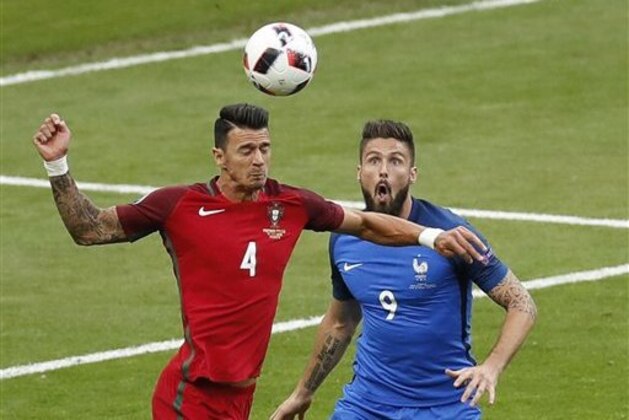 France's Olivier Giroud, right, looks on as Portugal's Jose Fonte heads a ball during the Euro 2016 final soccer match between Portugal and France at the Stade de France in Saint-Denis, north of Paris, Sunday, July 10, 2016. (AP Photo/Michael Sohn)
