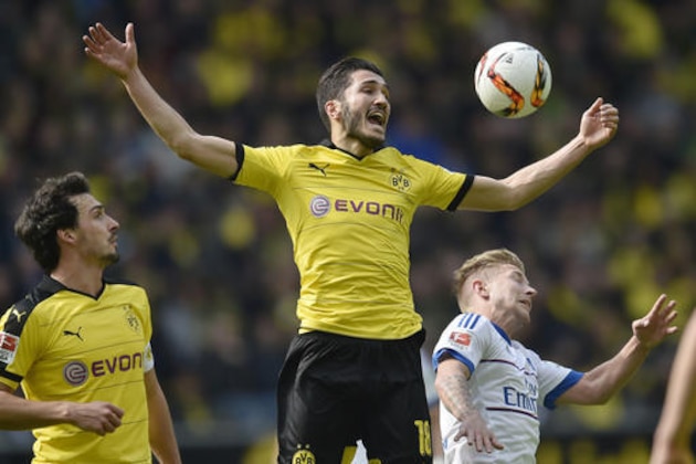 Dortmund's Nuri Sahin, up, and Hamburg's Lewis Holtby, right, challenge for the ball during the German Bundesliga soccer match between Borussia Dortmund and Hamburger SV in Dortmund, Germany, Sunday, April 17, 2016. (AP Photo/Martin Meissner)