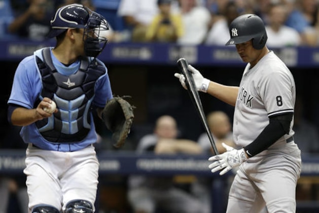 New York Yankees' Alex Rodriguez, right, reacts after striking out against Tampa Bay Rays relief pitcher Alex Colome during the ninth inning of a baseball game Sunday, July 31, 2016, in St. Petersburg, Fla. Rays catcher Luke Maile looks on. (AP Photo/Chris O'Meara)