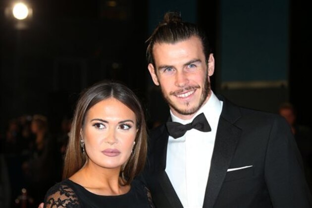 Gareth Bale, right, and Emma Rhys-Jones pose for photographers on arrival for the World Premiere of the latest Bond film, Spectre, at the Royal Albert Halll in central London, Monday, Oct. 26, 2015. (Photo by Joel Ryan/Invision/AP)