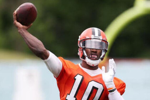 File- This June 7, 2016, file photo shows Cleveland Browns quarterback Robert Griffin III throwing during NFL football mini camp at the practice facility in Berea, Ohio.  Cleveland Browns coach Hue Jackson said he will name his starting quarterback for this season before the team’s first exhibition game next month. The Browns will open the preseason on Aug. 12 at Green Bay and Jackson said he will “definitely” have his starter in place by then. Griffin is expected to win the starting job over veteran Josh McCown and rookie Cody Kessler. (AP Photo/Ron Schwane, File)