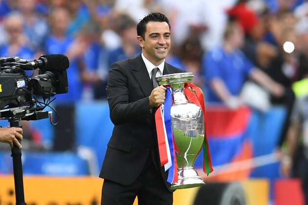 Former Spanish international player Xavi presents the trophy ahead of the Euro 2016 final football match between Portugal and France at the Stade de France in Saint-Denis, north of Paris, on July 10, 2016. / AFP / PATRIK STOLLARZ        (Photo credit should read PATRIK STOLLARZ/AFP/Getty Images)