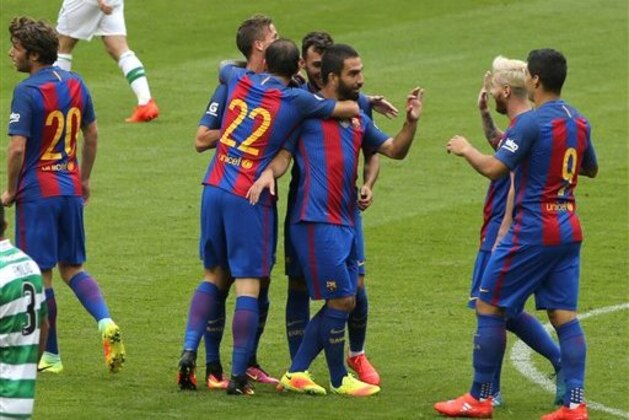 IMAGE DISTRIBUTED FOR INTERNATIONAL CHAMPIONS CUP - Barcelona's Arda Turan is congratulated by captain Lionel Messi after Turan scored the first goal, on Saturday, July 30, 2016, in Dublin. (Peter Morrison/AP Images for International Champions Cup)
