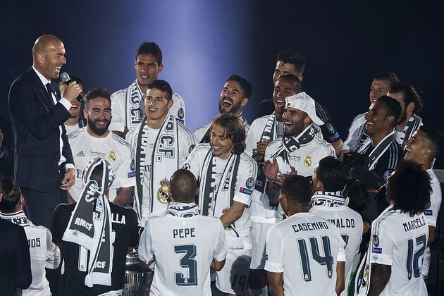 MADRID, SPAIN - MAY 29: Head coach Zinedine Zidane of Real Madrid CF jokes with his players as they celebrate with their fans at Santiago Bernabeu Stadium the day after winning the UEFA Champions League Final match against Club Atletico de Madrid on May 29, 2016 in Madrid, Spain. Real Madrid CF is the only European football team with 11 European Cups (Photo by Gonzalo Arroyo Moreno/Getty Images)
