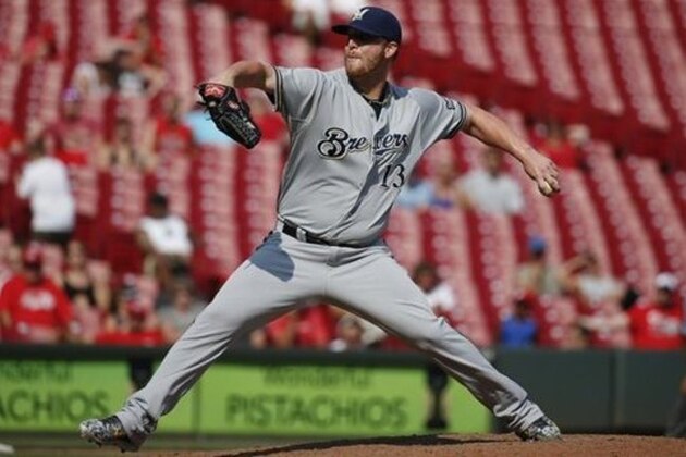 Milwaukee Brewers relief pitcher Will Smith throws in the eighth inning in the first game of a baseball doubleheader against the Cincinnati Reds, Saturday, Sept. 5, 2015, in Cincinnati. The Brewers won 8-6. (AP Photo/John Minchillo)