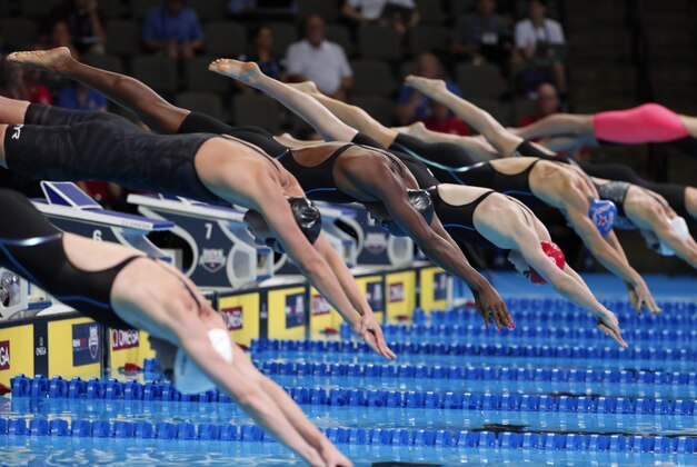 Jun 30, 2016; Omaha, NE, USA; Simone Manuel (4) leaves the starting blocks during the Women's 100 Meter Freestyle preliminary heats in the U.S. Olympic swimming team trials at CenturyLink Center. Mandatory Credit: Erich Schlegel-USA TODAY Sports