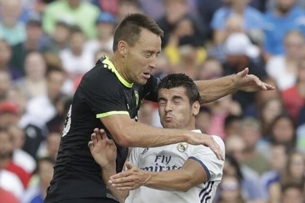 Real Madrid forward Alvaro Morata, right, and Chelsea defender John Terry contest for a header during the first half of the International Champions Cup soccer match at Michigan Stadium in Ann Arbor, Mich., Saturday, July 30, 2016. (AP Photo/Carlos Osorio)