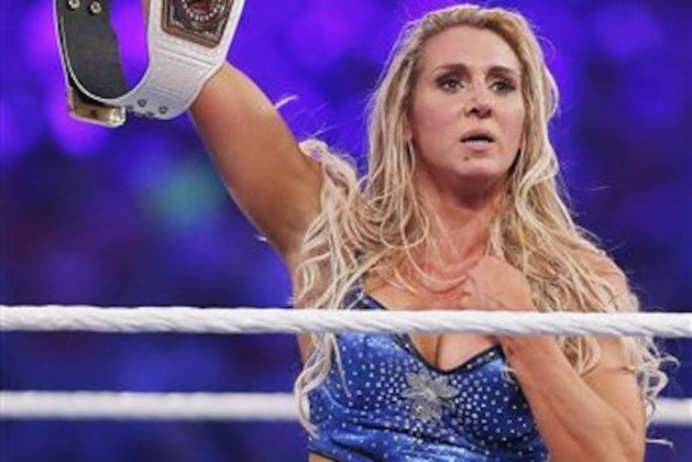 IMAGE DISTRIBUTED FOR WWE - WWE women's champion Charlotte celebrates her victory at WWE WrestleMania 32 at AT&T Stadium on Sunday, April 3, 2016, in Arlington, Texas. (Brandon Wade/AP Images for WWE)
