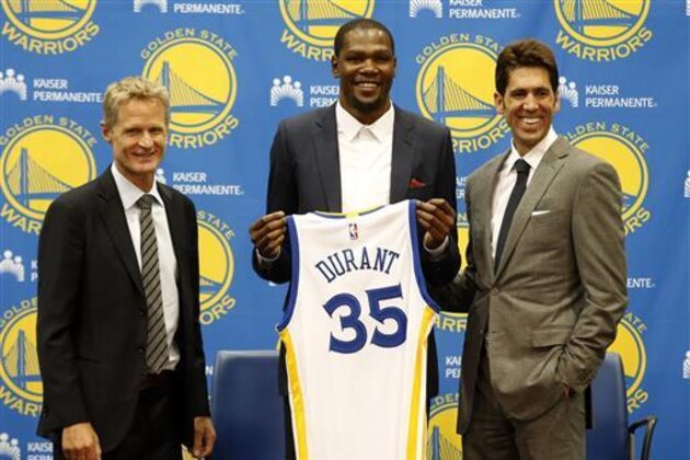 Golden State Warriors' newest player Kevin Durant, center, joins head coach Steve Kerr, left and general manager Bob Myers during a news conference at the NBA basketball team's practice facility, Thursday, July 7, 2016, in Oakland, Calif. (AP Photo/Beck Diefenbach)