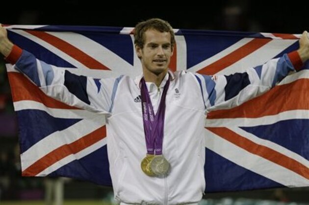 Andy Murray of Great Britain poses with his gold and silver medals in tennis at the All England Lawn Tennis Club in Wimbledon, London at the 2012 Summer Olympics, Sunday, Aug. 5, 2012. (AP Photo/Mark Humphrey)