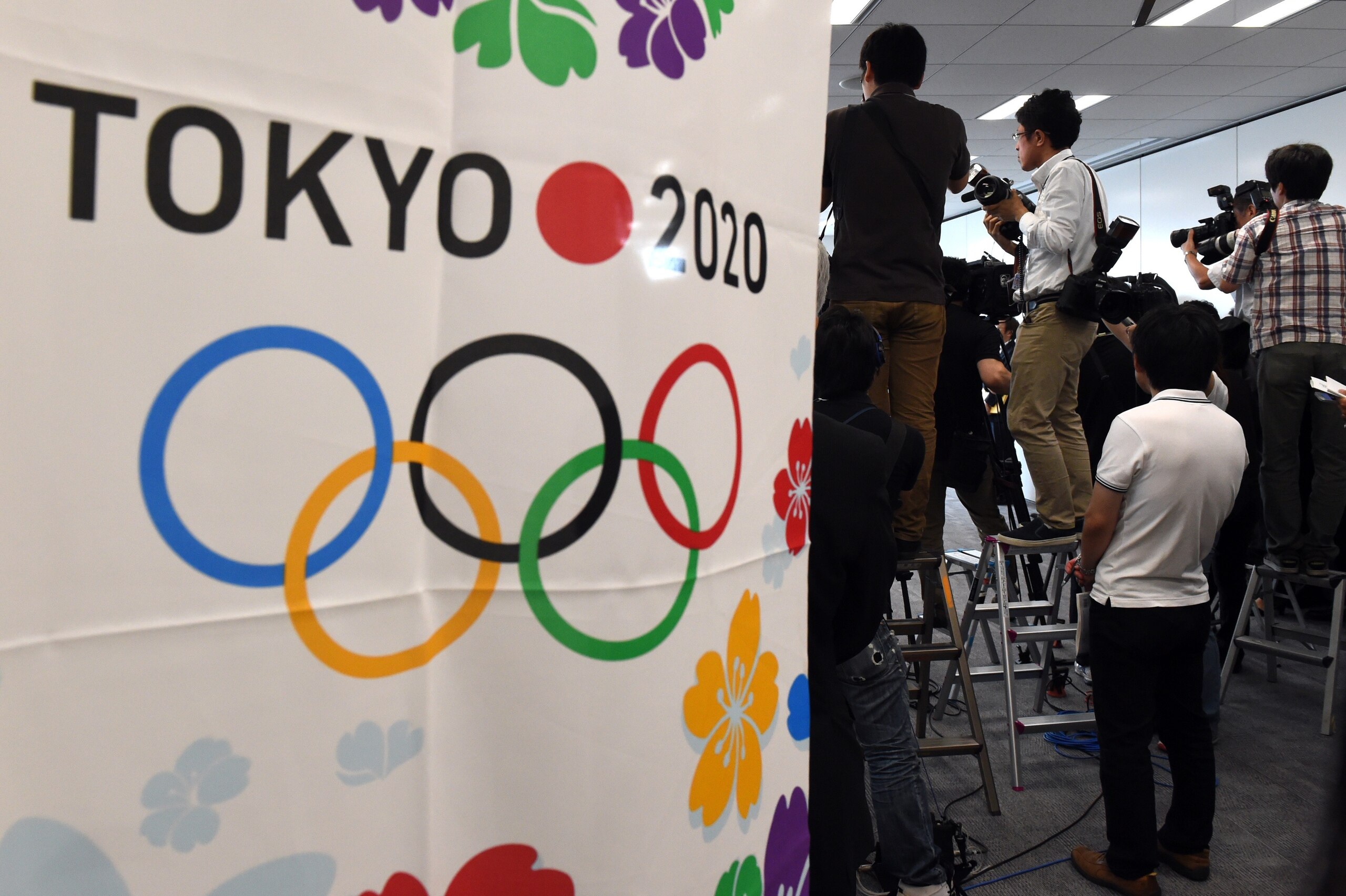 Photographers take pictures during the meeting of the Tokyo 2020 additional event programme panel at the Tokyo 2020 organising committee headquarters in Tokyo on June 22, 2015. The organisers nominated eight new sports for possible inclusion in the Tokyo Games, including baseball.    AFP PHOTO / TOSHIFUMI KITAMURA        (Photo credit should read TOSHIFUMI KITAMURA/AFP/Getty Images)