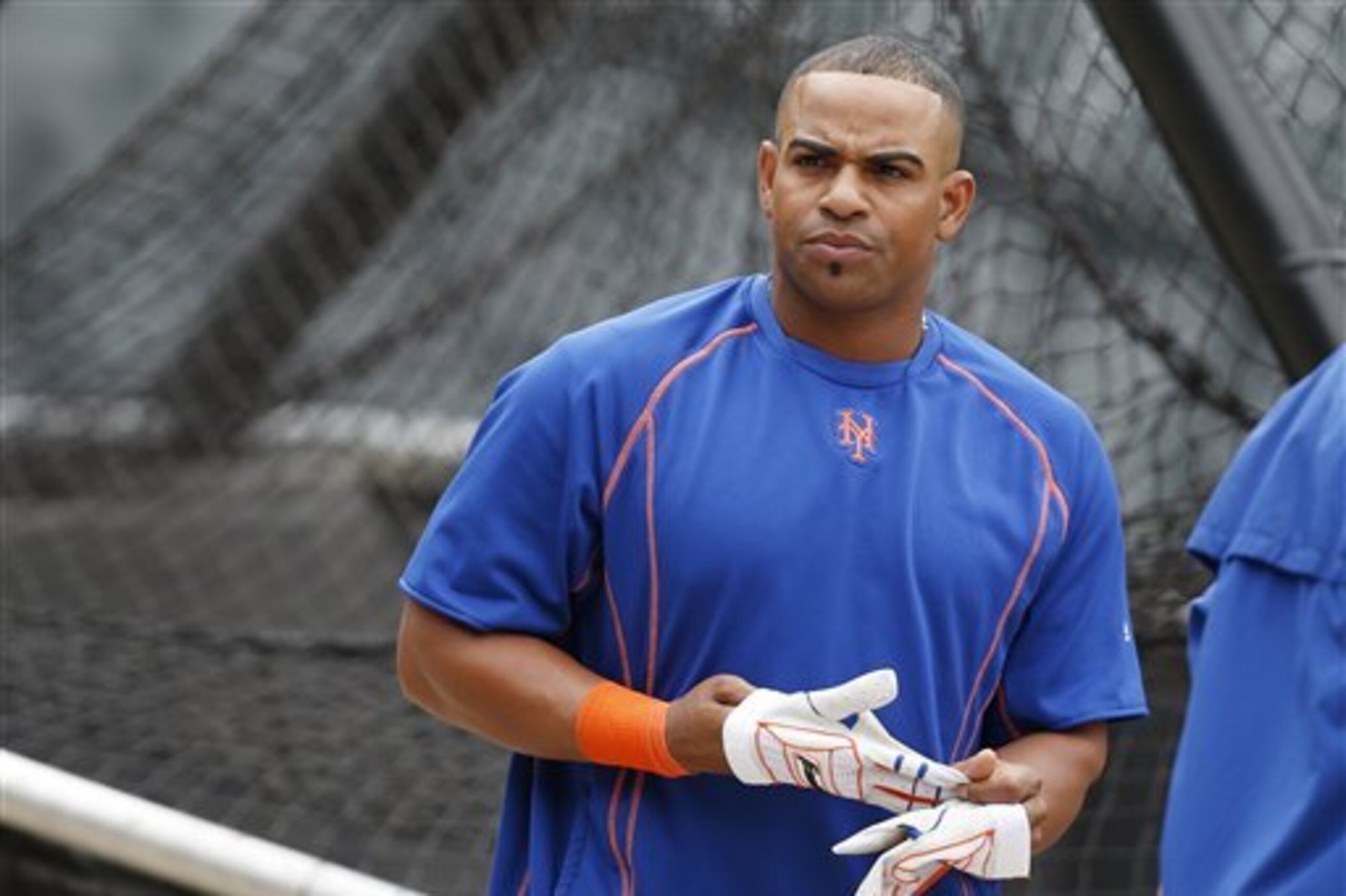 New York Mets center fielder Yoenis Cespedes removes his batting gloves before an interleague baseball game against the New York Yankees, Tuesday, Aug. 2, 2016, in New York.  (AP Photo/Kathy Willens)