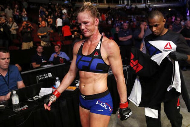 Holly Holm leaves after she lost to Valentina Shevchenko, of Kyrgyzstan, in a women's bantamweight mixed martial arts bout at United Center in Chicago, Saturday, July 23, 2016. (AP Photo/Nam Y. Huh)