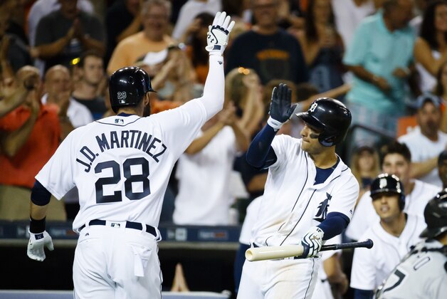 Aug 3, 2016; Detroit, MI, USA; Detroit Tigers J.D. Martinez (28) receives congratulations from shortstop Jose Iglesias (1)  after he hits a pinch hit home run in the eighth inning against the Chicago White Sox at Comerica Park. Detroit won 2-1. Mandatory Credit: Rick Osentoski-USA TODAY Sports