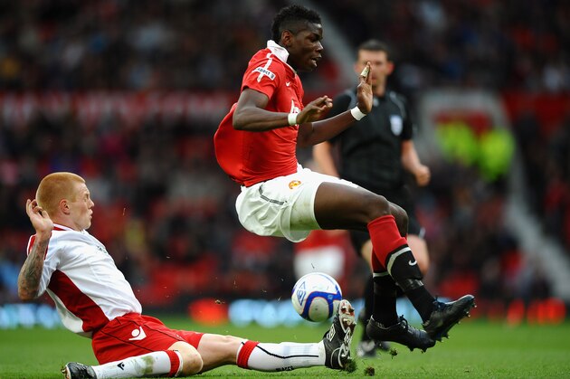 MANCHESTER, ENGLAND - MAY 23:   Paul Pogba of Manchester United is tackled by Terry Kennedy of Sheffield United during the FA Youth Cup Final 2nd Leg match between Manchester United and Sheffield United at Old Trafford on May 23, 2011 in Manchester, England.  (Photo by Laurence Griffiths/Getty Images)