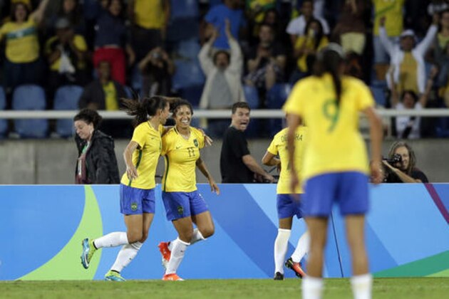 Brazil's Cristiane ( 11 ), celebrates with team mates after scoring her team's third goal during a Group E match of the women's Olympic football tournament between Brazil and China at the Rio Olympic Stadium in Rio de Janeiro, Brazil, Wednesday, Aug. 3, 2016.(AP Photo/Leo Correa)