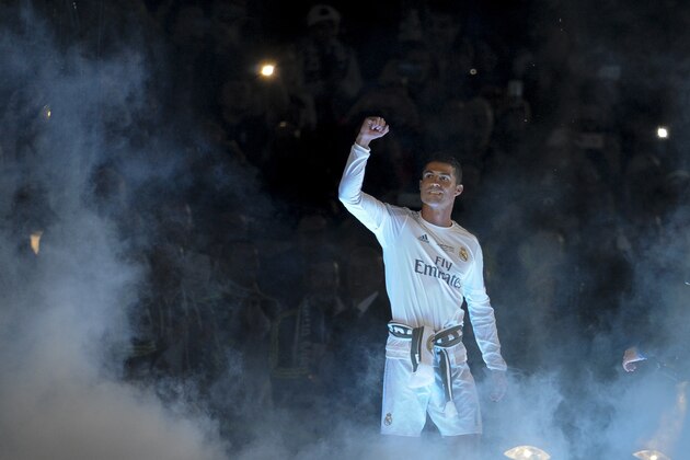 TOPSHOT - Real Madrid's Portuguese forward Cristiano Ronaldo acknowledges supporters during Real celebrations for their 11th UEFA Champions Cup at the Santiago Bernabeu stadium in Madrid on May 29, 2016, a day after winning the UEFA Champions League final foobtall match between Real Madrid CF, Club Atletico de Madrid held in Milan, Italy on May 28, 2016.  / AFP / PEDRO ARMESTRE        (Photo credit should read PEDRO ARMESTRE/AFP/Getty Images)