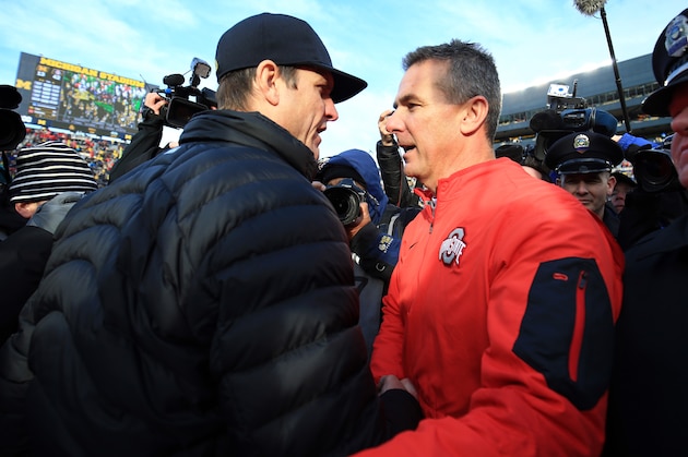ANN ARBOR, MI - NOVEMBER 28: Head coach Urban Meyer of the Ohio State Buckeyes and head coach Jim Harbaugh of the Michigan Wolverines after the game against the Michigan Wolverines at Michigan Stadium on November 28, 2015 in Ann Arbor, Michigan. Ohio State defeated Michigan 42-13. (Photo by Andrew Weber/Getty Images)