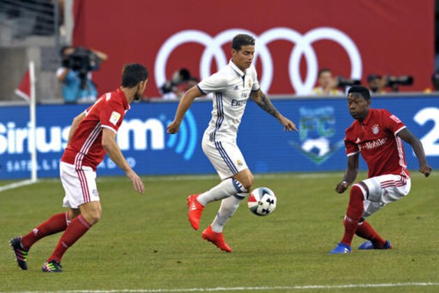 Real Madrid's James Rodriquez controls the ball between Bayern Munich's Xabi Alonso, left, and David Alaba during the first half of their friendly soccer match Wednesday, Aug. 3, 2016, in East Rutherford, N.J. Real Madrid won 1-0.(AP Photo/Bill Kostroun)