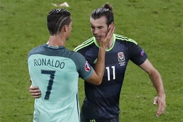 Portugal's Cristiano Ronaldo, left, comforts Wales' Gareth Bale after Portugal won 2-0 during the Euro 2016 semifinal soccer match between Portugal and Wales, at the Grand Stade in Decines-Charpieu, near Lyon, France, Wednesday, July 6, 2016. (AP Photo/Michael Sohn) Portugal's Cristiano Ronaldo, left, comforts Wales' Gareth Bale after Portugal won 2-0 during the Euro 2016 semifinal soccer match between Portugal and Wales, at the Grand Stade in Decines-Charpieu, near Lyon, France, Wednesday, July 6, 2016. (AP Photo/Michael Sohn)