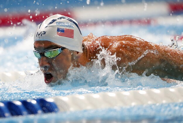 Jul 1, 2016; Omaha, NE, USA; Michael Phelps swims during the men's 100 meter butterfly semifinal in the U.S. Olympic swimming team trials at CenturyLink Center. Mandatory Credit: Erich Schlegel-USA TODAY Sports