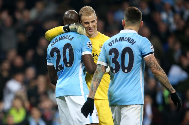MANCHESTER, ENGLAND - APRIL 12: Goalkeeper of Manchester City Joe Hart greets Eliaquim Mangala while Nicolas Otamendi of Manchester City looks on during the UEFA Champions League quarter final second leg match between Manchester City and Paris Saint-Germain (PSG) at Etihad Stadium on April 12, 2016 in Manchester, United Kingdom. (Photo by Jean Catuffe/Getty Images)