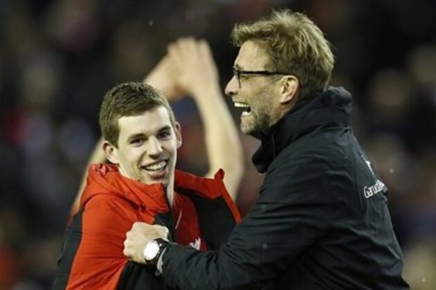 Liverpool's manager Juergen Klopp, right, celebrates with player Jon Flanagan after winning the English League Cup semifinal second leg soccer match between Liverpool and Stoke City at Anfield stadium in Liverpool, England, Tuesday, Jan. 26, 2016. (AP Photo/Jon Super)