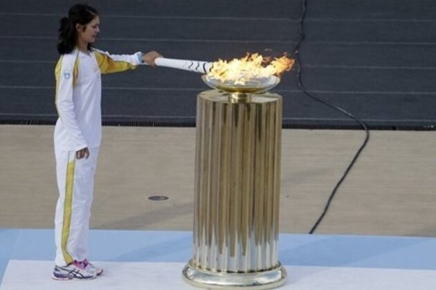 Rowing World Champion Katerina Nikolaidou of Greece lights the cauldron during the handover ceremony for the Olympic Flame at Panathinean stadium in Athens, Wednesday, April 27, 2016. The flame arrives in Brazil on May 3, and will be relayed across the vast country by about 12,000 torchbearers before the Aug. 5 opening ceremony in Rio de Janeiro's Maracana Stadium. (AP Photo/Thanassis Stavrakis)