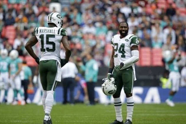 New York Jets Brandon Marshall, left, and Darrelle Revis during the warm-up before the NFL football game between the New York Jets and the Miami Dolphins and at Wembley stadium in London, Sunday, Oct. 4, 2015. (AP Photo/Matt Dunham)