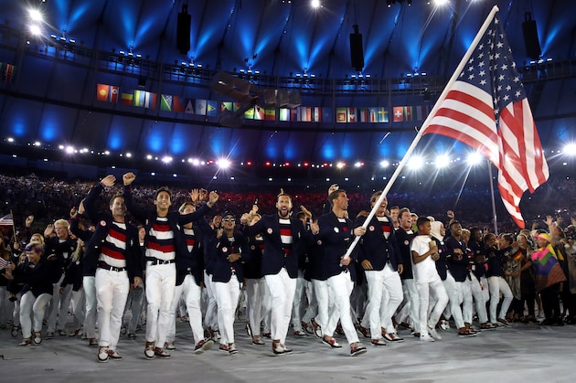 RIO DE JANEIRO, BRAZIL - AUGUST 05:  Michael Phelps of the United States carries the flag during the Opening Ceremony of the Rio 2016 Olympic Games at Maracana Stadium on August 5, 2016 in Rio de Janeiro, Brazil.  (Photo by Cameron Spencer/Getty Images)