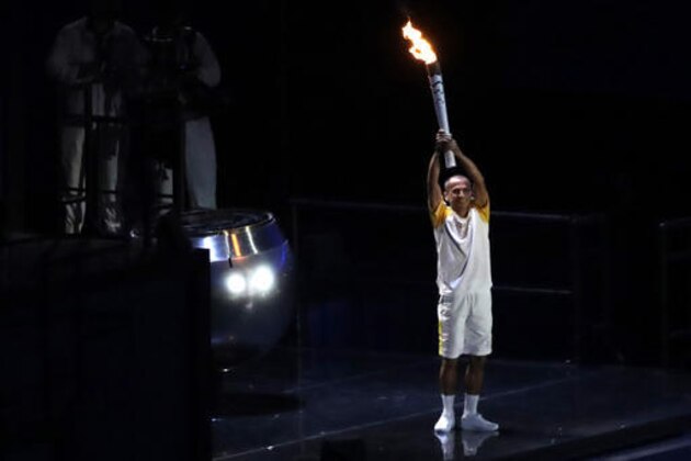 Brazilian former long-distance runner Vanderlei de Lima holds the Olympic flame during the opening ceremony of the 2016 Summer Olympics in Rio de Janeiro, Brazil, Saturday, Aug. 6, 2016. (AP Photo/Robert F. Bukaty)