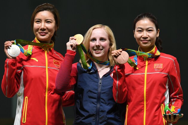 USA's gold medallist Virginia Thrasher (C) poses on the podium with China's silver medal winner Du Li (L) and China's bronze medallist Yi Siling during the medal ceremony for the women's 10m air rifle shooting event at the Rio 2016 Olympic Games at the Olympic Shooting Centre in Rio de Janeiro on August 6, 2016. / AFP / Pascal GUYOT        (Photo credit should read PASCAL GUYOT/AFP/Getty Images)