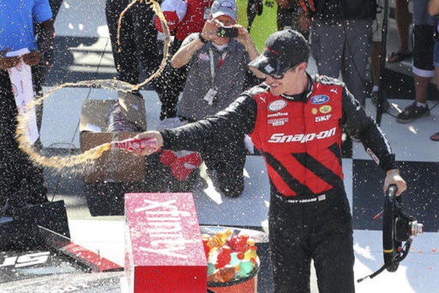 Joey Logano (12) celebrates in Victory Lane after winning the NASCAR Xfinity series auto race at Watkins Glen International, Saturday, Aug. 6, 2016, in Watkins Glen, N.Y. (AP Photo/Mel Evans)