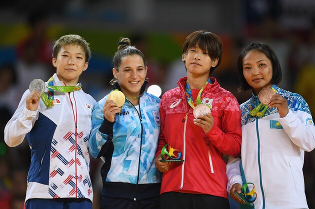 RIO DE JANEIRO, BRAZIL - AUGUST 06: Silver medalist Bokyeong Jeong of Korea, gold medalist Paula Pareto of Argentina, bronze medalist Ami Kondo of Japan and bronze medalist Otgontsetseg Galbadrakh of Kazakhstan stand on the podium after the Women's -48 kg Judo competition on Day 1 of the Rio 2016 Olympic Games at Carioca Arena 2 on August 6, 2016 in Rio de Janeiro, Brazil. (Photo by Laurence Griffiths/Getty Images)