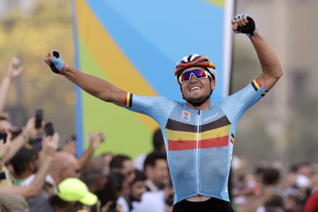 Greg Van Avermaet of Belgium celebrates after crossing the finish line to win the men's cycling road race final at the 2016 Summer Olympics in Rio de Janeiro, Brazil, Saturday, Aug. 6, 2016. (AP Photo/Patrick Semansky)