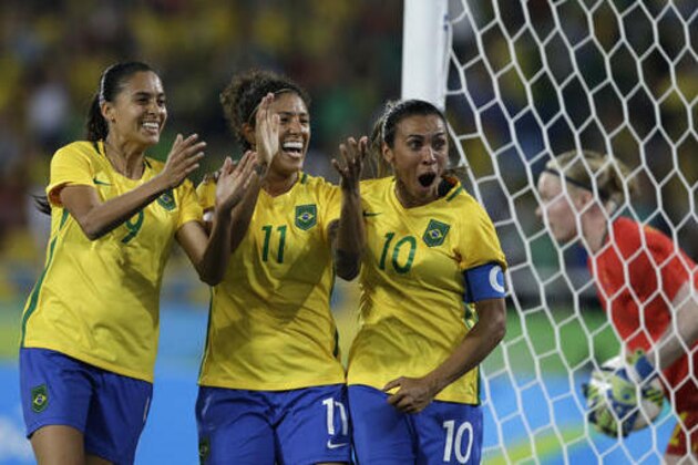 Brazil's Andressa Alves, left, Cristiane, center, and Marta celebrate after their side's second goal during a group E match of the women's Olympic football tournament between Sweden and Brazil at the Rio Olympic Stadium in Rio De Janeiro, Brazil, Saturday, Aug. 6, 2016. Brazil won the game 5-1. (AP Photo/Leo Correa)