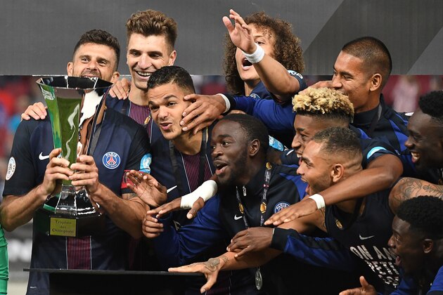 Players of Paris Saint-Germain celebrate with the trophy after winning the French Supercup Champions trophy (Trophée des Champions) football match Paris Saint-Germain vs Olympique Lyonnais in Klagenfurt, Austria, on August 6, 2016. / AFP / BORIS HORVAT        (Photo credit should read BORIS HORVAT/AFP/Getty Images)