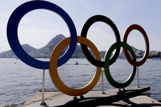 Akossiwa Claire Ayivon, of Togo, rows past the Olympic rings after competing in the women's single scull heat during the 2016 Summer Olympics in Rio de Janeiro, Brazil, Saturday, Aug. 6, 2016. (AP Photo/Matt York)