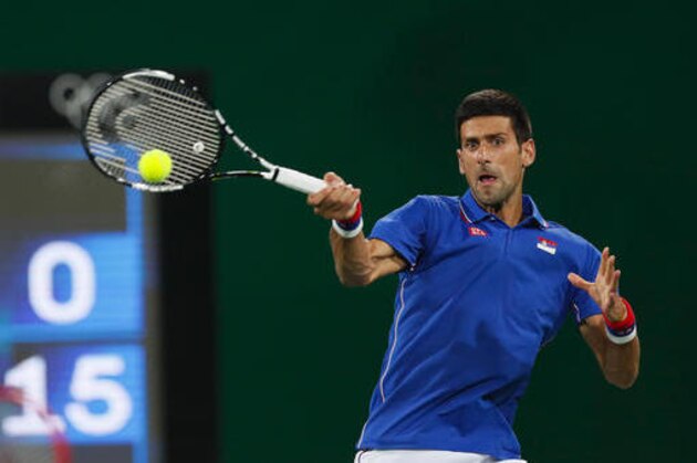 Serbia's Novak Djokovic returns a ball during the doubles match he and Nenad Zimonjic play against Croatia's Marin Cilic and Marin Draganja in the men's tennis competition at the 2016 Summer Olympics in Rio de Janeiro, Brazil, Saturday, Aug. 6, 2016. (AP Photo/Vadim Ghirda)