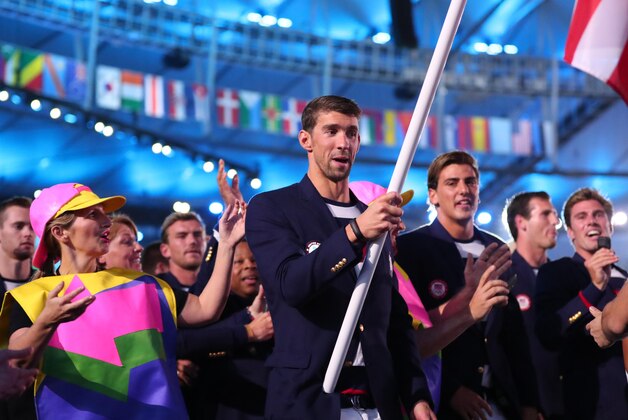 Aug 5, 2016; Rio de Janeiro, Brazil; USA flag bearer Michael Phelps leads the team into the stadium during the opening ceremonies for the Rio 2016 Summer Olympic Games at Maracana. Mandatory Credit: Rob Schumacher-USA TODAY Sports