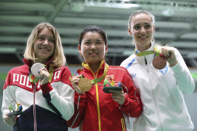 Vitalina Batsarashkina, left, of Russia, Zhang Mengxue, center, of China and Anna Korakaki, right, of Greece pose for photographers after the award ceremony for the women's 10-meter air pistol event at Olympic Shooting Center at the 2016 Summer Olympics in Rio de Janeiro, Brazil, Sunday, Aug. 7, 2016. Zhang won the gold medal. Batsarashkina won the silver medal and Korakaki finished with the bronze. (AP Photo/Eugene Hoshiko)