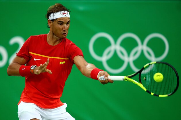 RIO DE JANEIRO, BRAZIL - AUGUST 07:  Rafael Nadal of Spain plays a forehand against Federico Delbonis of Argentina  in their first round match on Day 2 of the Rio 2016 Olympic Games at the Olympic Tennis Centre on August 7, 2016 in Rio de Janeiro, Brazil.  (Photo by Clive Brunskill/Getty Images)