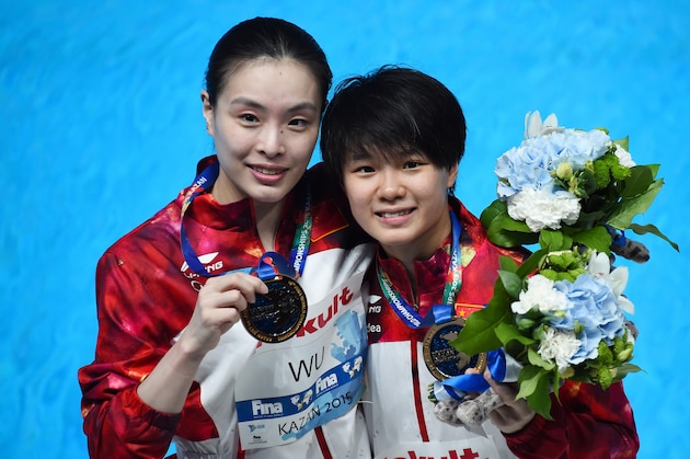 Chinese divers Shi Tingmao and Wu Minxia pose with their gorld medal during the podium ceremony of the women's 3m Springboard Synchronised final diving event at the 2015 FINA World Championships in Kazan on July 25, 2015.  AFP PHOTO / CHRISTOPHE SIMON        (Photo credit should read CHRISTOPHE SIMON/AFP/Getty Images)