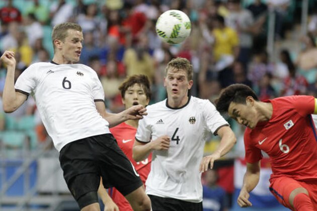 Germany's Sven Bender, left, Germany's Mathias Ginter, center, and South Korea's Jang Hyunsoo jump for the ball during a group C match of the men's Olympic football tournament between Germany and South Korea at the Fonte Nova Arena in Salvador, Brazil, Sunday, Aug. 7, 2016. (AP Photo/Arisson Marinho)